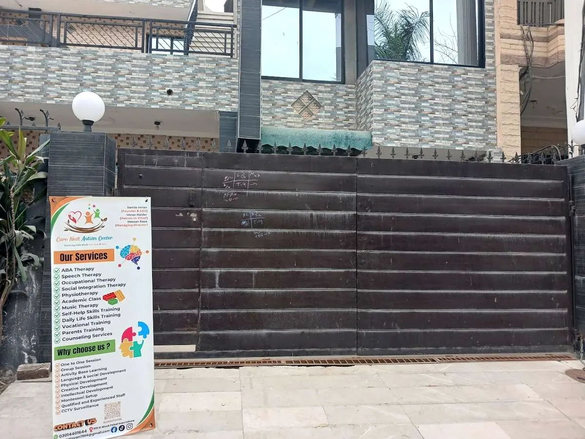 The gate of Care Nest Autism Centre with its banner